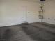 A garage featuring finished concrete floor with water heater and door to the outside at 5481 Railroad River Ave, Las Vegas, NV 89139