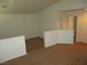 Carpeted loft area with white walls and railing, offering versatile space at 5481 Railroad River Ave, Las Vegas, NV 89139