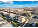Aerial view of a backyard featuring artificial grass, landscaping, a pool, and a covered patio at 5946 Ancient Peaks Ave, Las Vegas, NV 89141