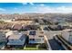 Aerial view of a backyard featuring artificial grass, landscaping, a pool, and a covered patio at 5946 Ancient Peaks Ave, Las Vegas, NV 89141