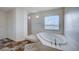 Luxurious bathroom featuring a soaking tub with marble surround and separate shower at 5946 Ancient Peaks Ave, Las Vegas, NV 89141
