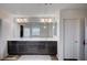 Stylish bathroom vanity with dual sinks, dark wood cabinets, and a large mirror at 5946 Ancient Peaks Ave, Las Vegas, NV 89141