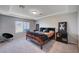 Bedroom with carpet, tray ceiling, large window, and decorative modern décor at 5946 Ancient Peaks Ave, Las Vegas, NV 89141