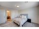 Bedroom with carpet, a cushioned headboard, natural light from the large window, and adjacent bathroom at 5946 Ancient Peaks Ave, Las Vegas, NV 89141