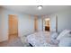 Bedroom with carpet, open closet, an adjacent bathroom and natural light from the large window at 5946 Ancient Peaks Ave, Las Vegas, NV 89141