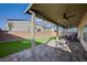 Beautiful covered patio with pavers, fan, BBQ, and putting green in backyard at 5946 Ancient Peaks Ave, Las Vegas, NV 89141