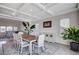 Open dining area with stylish table, chairs, buffet, coffered ceilings and natural light at 5946 Ancient Peaks Ave, Las Vegas, NV 89141