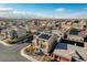 Aerial view of a two-story home boasting solar panels and desert landscaping in a large neighborhood at 5946 Ancient Peaks Ave, Las Vegas, NV 89141