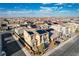 Aerial view of a two-story home boasting solar panels and desert landscaping in a large neighborhood at 5946 Ancient Peaks Ave, Las Vegas, NV 89141