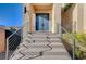 Close up on a blue double-door entry with steel railing and concrete stairs at 5946 Ancient Peaks Ave, Las Vegas, NV 89141
