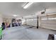 View of a large three car garage with an epoxy floor and overhead lighting at 5946 Ancient Peaks Ave, Las Vegas, NV 89141