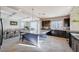 Spacious eat-in kitchen with large center island, granite counters, stainless appliances, and tile floors at 5946 Ancient Peaks Ave, Las Vegas, NV 89141