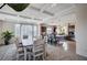 Open kitchen and dining area with island, granite countertops, tile floors, and coffered ceilings at 5946 Ancient Peaks Ave, Las Vegas, NV 89141