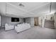 Neutral-toned living room with carpet, modern coffered ceiling and staircase leading to the second floor at 5946 Ancient Peaks Ave, Las Vegas, NV 89141