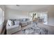 A spacious living room with neutral colored furnishings and a view of the dining room at 5946 Ancient Peaks Ave, Las Vegas, NV 89141