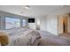 Comfortable main bedroom with large windows, a cozy bed, and an open doorway to the main bathroom at 5946 Ancient Peaks Ave, Las Vegas, NV 89141
