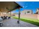 Stylish covered patio with brick flooring, ceiling fan, and outdoor seating at 5946 Ancient Peaks Ave, Las Vegas, NV 89141