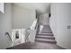 Bright staircase showcasing a modern design with neutral carpet and white walls at 5946 Ancient Peaks Ave, Las Vegas, NV 89141