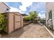 Backyard gardening area with storage shed and raised garden beds, mature trees, and covered patio at 6915 Cedar Basin Ave, Las Vegas, NV 89142