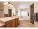 Elegant bathroom with a soaking tub, double sinks, and plenty of natural light at 6915 Cedar Basin Ave, Las Vegas, NV 89142