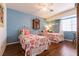 Twin bedroom design with light blue walls, hardwood floors, and metal bed frames at 6915 Cedar Basin Ave, Las Vegas, NV 89142