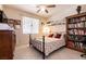 Cozy bedroom featuring tile floor, window, a bookcase, and a charming metal bed frame at 6915 Cedar Basin Ave, Las Vegas, NV 89142