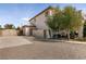 Home's exterior showcasing the side yard with mature landscaping, a gravel area, and privacy fencing at 6915 Cedar Basin Ave, Las Vegas, NV 89142