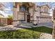 Charming two-story home with a three-car garage, covered porch, green lawn, and mature trees at 6915 Cedar Basin Ave, Las Vegas, NV 89142