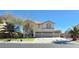 Spacious two-story home with a three-car garage, landscaped front yard, and a well-maintained lawn at 6915 Cedar Basin Ave, Las Vegas, NV 89142