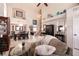 Spacious living room with a dining area, staircase, and lots of natural light at 6915 Cedar Basin Ave, Las Vegas, NV 89142