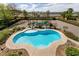 Aerial view of a sparkling pool with a covered pergola surrounded by mature landscaping and gravel paths at 6915 Cedar Basin Ave, Las Vegas, NV 89142