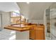 An open bar area with wooden countertops, a sink and mirrored storage in a well-lit, open space at 7425 Enchanted Hills Ct, Las Vegas, NV 89129