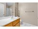 Bathroom featuring a wood vanity, white sink, toilet, and a decorative metal rack at 7425 Enchanted Hills Ct, Las Vegas, NV 89129