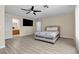 Bedroom featuring wood-look floors, a bed, and an open door to the ensuite bathroom at 7425 Enchanted Hills Ct, Las Vegas, NV 89129