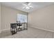 Cozy room with a desk, ceiling fan, tiled floor, neutral walls, and a window at 7425 Enchanted Hills Ct, Las Vegas, NV 89129
