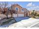 Attractive two-story home with a three-car garage, landscaped yard, and a sidewalk view at 7425 Enchanted Hills Ct, Las Vegas, NV 89129