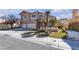 Charming home with a three-car garage, arched windows, and desert landscaping in the front yard at 7425 Enchanted Hills Ct, Las Vegas, NV 89129