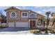 Two-story home featuring a three-car garage, well-maintained landscaping, and a classic tile roof at 7425 Enchanted Hills Ct, Las Vegas, NV 89129