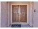 Elegant double front doors with decorative hardware on a stucco home at 7425 Enchanted Hills Ct, Las Vegas, NV 89129