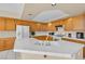 Bright eat-in kitchen with white appliances, tile countertops and backsplash, and ample cabinet space at 7425 Enchanted Hills Ct, Las Vegas, NV 89129
