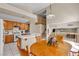 Eat-in kitchen with light wood cabinetry and view to living room, and tile countertops at 7425 Enchanted Hills Ct, Las Vegas, NV 89129