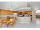 Open-concept kitchen with adjacent breakfast nook. View to Living Room and Wooden Stairs at 7425 Enchanted Hills Ct, Las Vegas, NV 89129