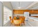 Eat-in kitchen featuring light wood cabinetry, white tile countertops and backyard views at 7425 Enchanted Hills Ct, Las Vegas, NV 89129