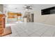 Open living room with fireplace, tile floors, staircase leading to an open kitchen and bar area at 7425 Enchanted Hills Ct, Las Vegas, NV 89129