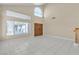 Open-concept living room with tile flooring, large windows, and modern pendant lighting at 7425 Enchanted Hills Ct, Las Vegas, NV 89129