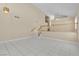Spacious living room featuring tile floors, high ceilings, staircase and contemporary lighting at 7425 Enchanted Hills Ct, Las Vegas, NV 89129