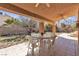 Covered patio features a ceiling fan, tile flooring, and an outdoor dining area, perfect for relaxing or entertaining at 7425 Enchanted Hills Ct, Las Vegas, NV 89129