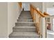 Carpeted staircase with wooden railings leading to the upper level, offering a seamless transition at 7425 Enchanted Hills Ct, Las Vegas, NV 89129