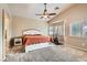 Spacious bedroom features a ceiling fan, and large windows with shutters allowing plenty of natural light at 7690 Blue Whirlpool St, Las Vegas, NV 89131