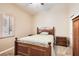 Cozy bedroom with wood furnishings, plush carpet, and a window providing natural light at 7690 Blue Whirlpool St, Las Vegas, NV 89131